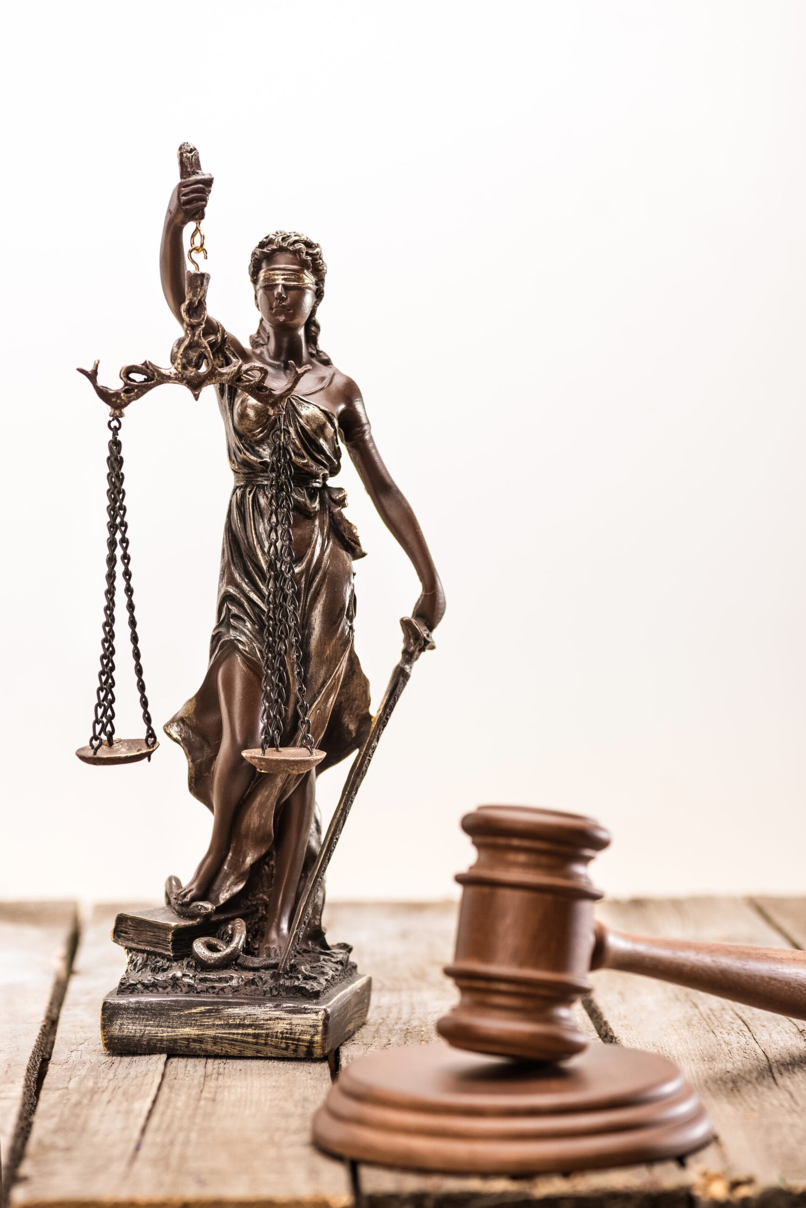 Close-up view of statue of lady justice and mallet, Law concept